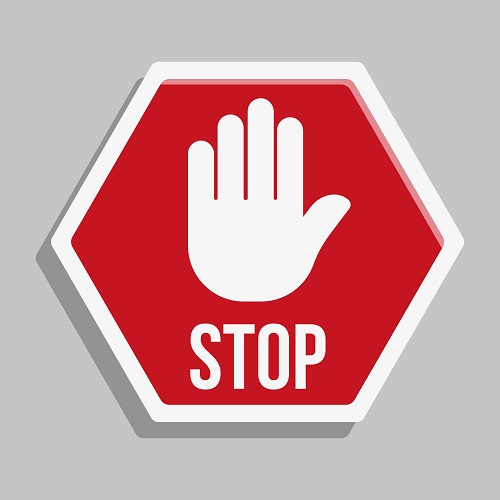 Stop sign with a hand and stop label